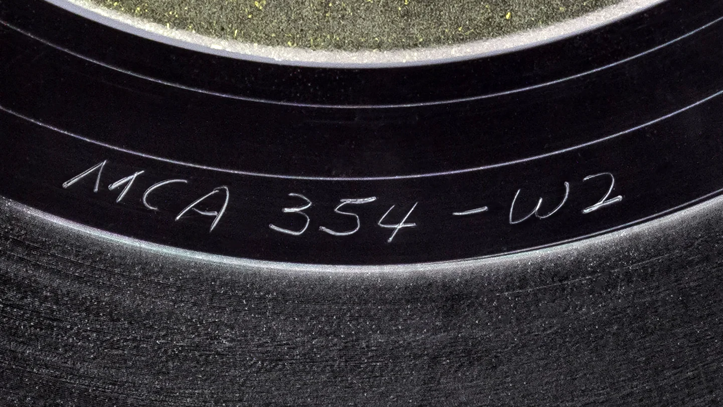 Hand-etched matrix number in the runout of an Elton John LP